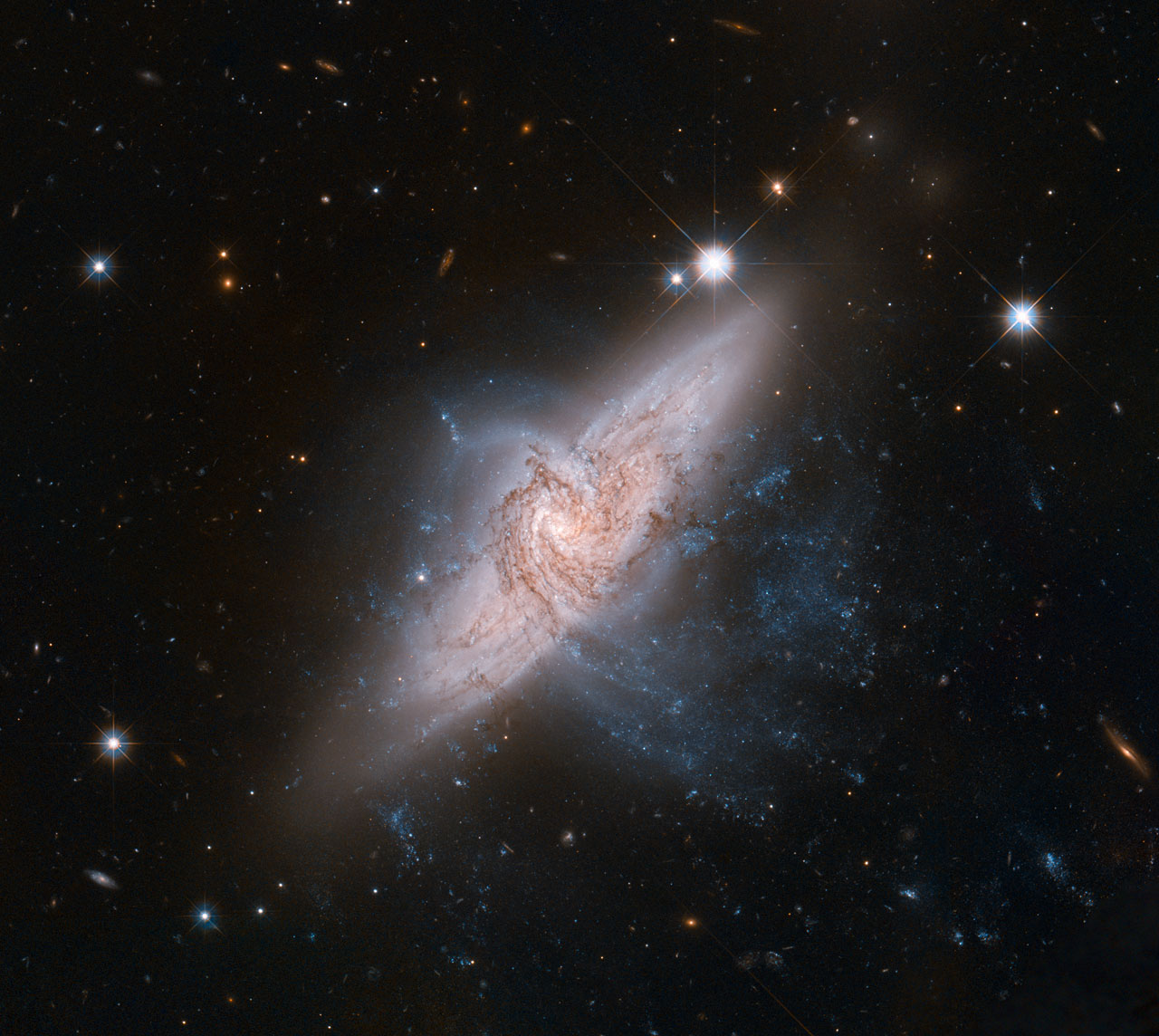 The NASA/ESA Hubble Space Telescope has produced an incredibly detailed image of a pair of overlapping galaxies called NGC 3314. While the two galaxies look as if they are in the midst of a collision, this is in fact a trick of perspective: the two are in chance alignment from our vantage point.