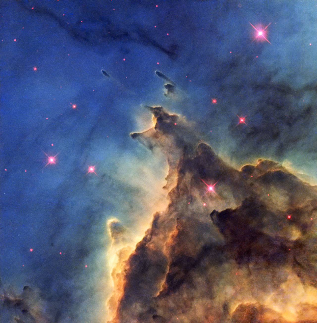 The NASA/ESA Hubble Space Telescope has imaged a violent stellar nursery called NGC 2174, in which stars are born in a first-come-first-served feeding frenzy for survival. The problem is that star formation is a very inefficient process; most of the ingredients to make stars are wasted as the cloud of gas and dust, or nebula, gradually disperses. In NGC 2174, the rate at which the nebula disperses is further speeded up by the presence of hot young stars, which create high velocity winds that blow the gas outwards. These fiery youngsters also bombard the surrounding gas with intense radiation, making it glow brightly, creating the brilliant scene captured here. The nebula is mostly composed of hydrogen gas, which is ionised by the ultraviolet radiation emitted by the hot stars, leading to the nebula’s alternative title as an HII region. This picture shows only part of the nebula, where dark dust clouds are strikingly silhouetted against the glowing gas. NGC 2174 lies about 6400 light-years away in the constellation of Orion (The Hunter). It is not part of the much more familiar Orion Nebula, which lies much closer to us. Despite its prime position in a very familiar constellation this nebula is faint and had to wait until 1877 for its discovery by the French astronomer Jean Marie Edouard Stephan using an 80 cm reflecting telescope at the Observatoire de Marseille. This picture was created from images from the Wide Field Planetary Camera 2 on Hubble. Images through four different filters were combined to make the view shown here. Images through a filter isolating the glow from ionised oxygen (F502N) were coloured blue and images through a filter showing glowing hydrogen (F656N) are green. Glowing ionised sulphur (F673N) and the view through a near-infrared filter (F814W) are both coloured red. The total exposure times per filter were 2600 s, 2600 s, 2600 s and 1000 s  respectively and the field of view is about 1.8 arcminutes across.