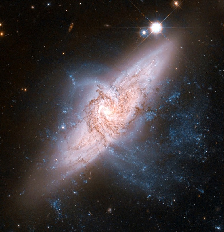 The NASA/ESA Hubble Space Telescope has produced an incredibly detailed image of a pair of overlapping galaxies called NGC 3314. While the two galaxies look as if they are in the midst of a collision, this is in fact a trick of perspective: the two are in chance alignment from our vantage point.