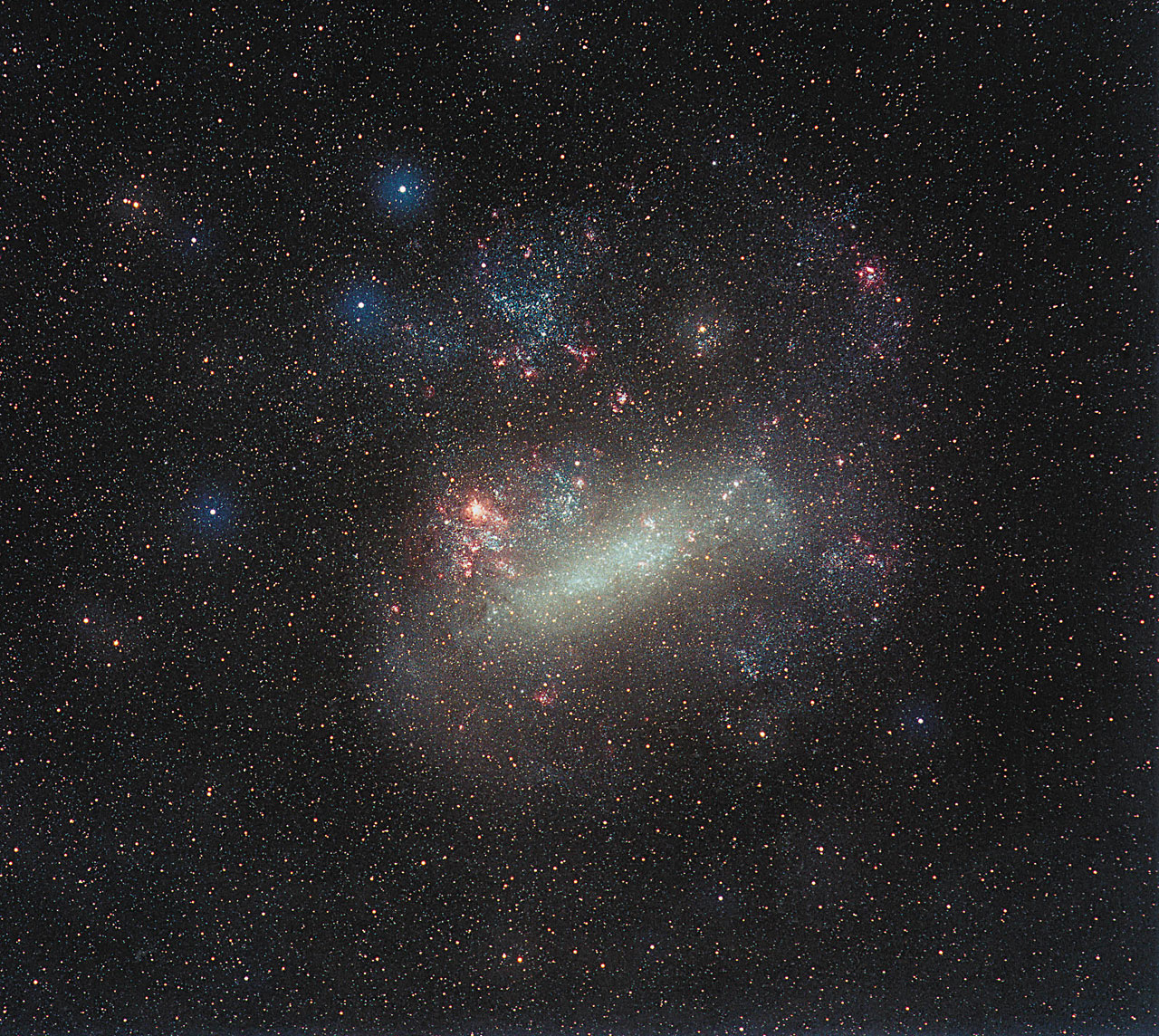 This ground-based image of the Large Magellanic Cloud was taken by the German astrophotographer Eckhard Slawik. It spans 10 x 10 degrees. Just to the left of the middle of this image the largest star-forming region in the Local Group of galaxies, 30 Doradus, is seen as a red patch. N11B itself is seen in the upper right part of the LMC.