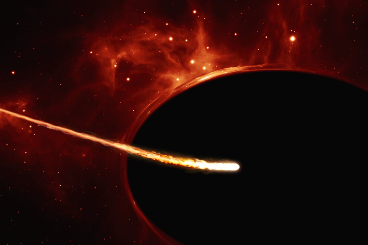 This artist’s impression depicts a Sun-like star close to a rapidly spinning supermassive black hole, with a mass of about 100 million times the mass of the Sun, in the centre of a distant galaxy. Its large mass bends the light from stars and gas behind it. Despite being way more massive than the star, the supermassive black hole has an event horizon which is only 200 times larger than the size of the star. Its fast rotation has changed its shape into an oblate sphere. The gravitational pull of the supermassive black hole rips the the star apart in a tidal disruption event. In the process, the star was “spaghettified” and shocks in the colliding debris as well as heat generated in accretion led to a burst of light.
