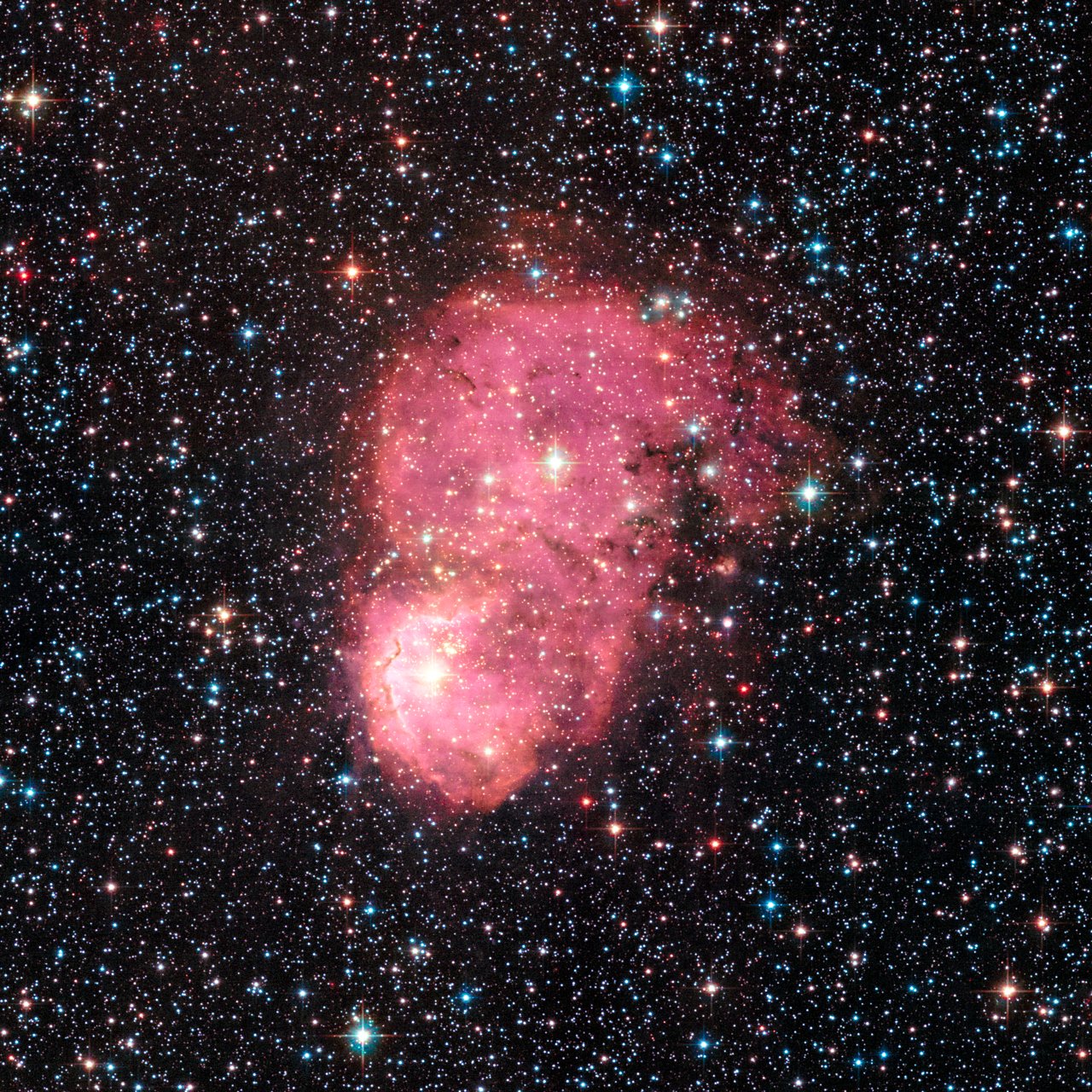 This glowing nebula, named NGC 248, is located within the Small Magellanic Cloud, a satellite galaxy of the Milky Way and about 200 000 light-years from Earth. The nebula was observed with Hubble’s Advanced Camera for Surveys in September 2015, as part of a survey called the Small Magellanic cloud Investigation of Dust and Gas Evolution (SMIDGE).