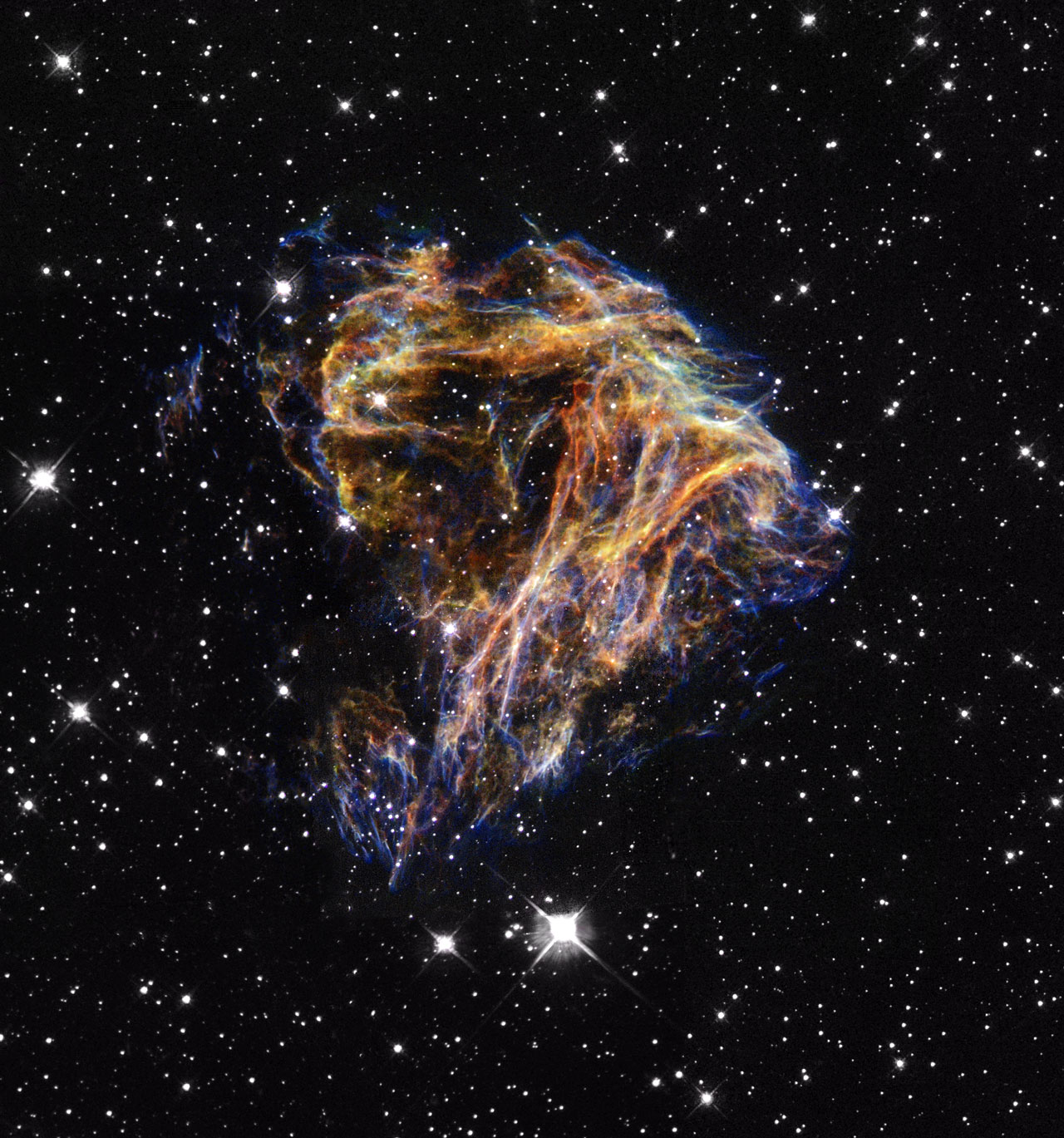 Resembling the puffs of smoke and sparks from a summer fireworksdisplay in this image from NASA/ESA Hubble Space Telescope, these delicate filaments are actually sheets of debris from a stellar explosion in a neighboring galaxy. Hubble's target was a supernova remnant within the Large Magellanic Cloud (LMC), a nearby, small companion galaxy to the Milky Way visible from the southern hemisphere. Denoted N 49, or DEM L 190, this remnant is from a massive star that died in a supernova blast whose light would have reached Earth thousands of years ago. This filamentary material will eventually be recycled into building new generations of stars in the LMC. Our own Sun and planets are constructed from similar debris of supernovae that exploded in the Milky Way billions of years ago.