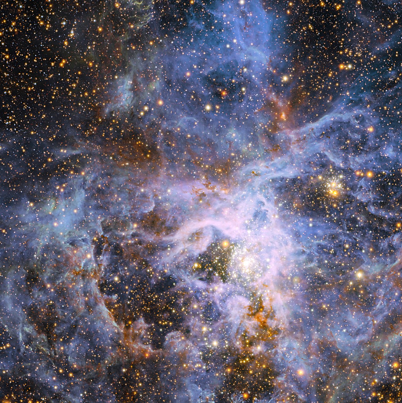 This view shows part of the very active star-forming region around the Tarantula Nebula in the Large Magellanic Cloud, a small neighbour of the Milky Way. At the exact centre lies the brilliant but isolated star VFTS 682 and to its lower right the very rich star cluster R 136. The origins of VFTS 682 are unclear — was it ejected from R 136 or did it form on its own? The star appears yellow-red in this view, which includes both visible-light and infrared images from the Wide Field Imager at the 2.2-metre MPG/ESO telescope at La Silla and the 4.1-metre infrared VISTA telescope at Paranal, because of the effects of dust.